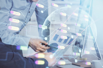 Double exposure of world map hologram with man working on computer on background. Concept of worldwideweb.