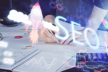 Man writing. With double exposure seo drawings.