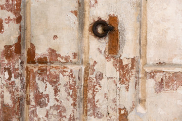 old shabby damaged plaster on the walls of houses close-up