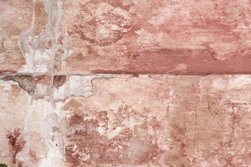 old shabby damaged plaster on the walls of houses close-up