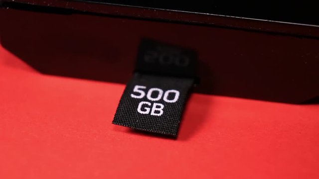 Close Up Of Gaming Console 500 GB Hard Drive On Red Background.