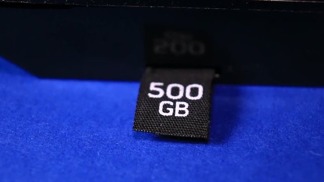 Close Up Of Gaming Console 500 GB Hard Drive On Blue Red Background.