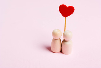 The concept of love, romance.Figurines of a woman and a man with a heart