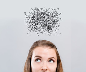 Doodles with young woman looking upwards on a gray background