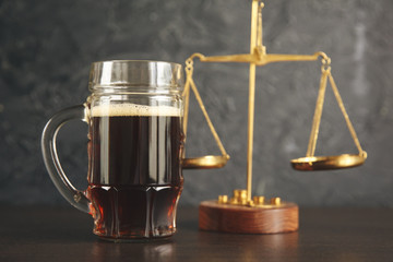 The concept of a DUI. Law hammer, alcohol and car keys on wooden table, dark background