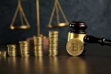 Auction gavel and bitcoin cryptocurrency money on a wooden desk, close-up. Law Gavel and golden bitcoin symbol on white background with copyspace