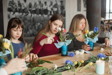 Floral maser-class. Women making a floral composition with fresh flowers.