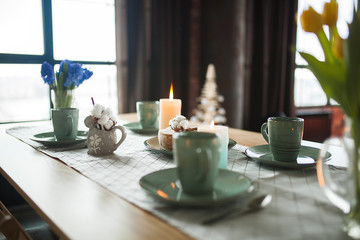 Table with cups and plates on rustic background. Loft interior.