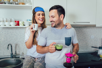 Young couple enjoying a morning coffee at home.