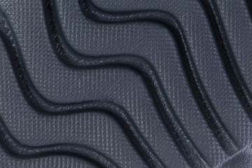 Fragment of a rubber black sole sneaker. Bottom of sports shoes