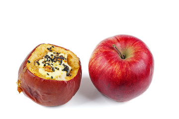 Red fresh and stuffed baked apples with sezame seeds and walnuts isolated on a white background