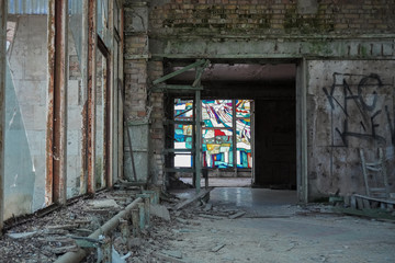 Fototapeta na wymiar A stained glass window remains intact in an abandoned restaurant in Pripyat, Ukraine, near Chernobyl