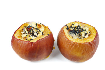 Stuffed baked apples with sezame seeds and walnuts isolated on a white background