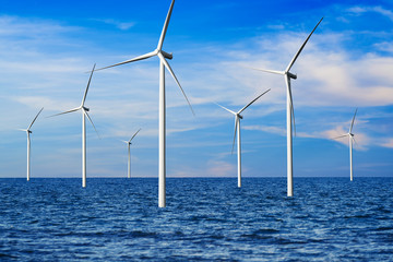 Wind turbine farm power generator in beautiful nature landscape for production of renewable green energy is friendly industry to environment. Concept of sustainable development technology. © InfiniteFlow