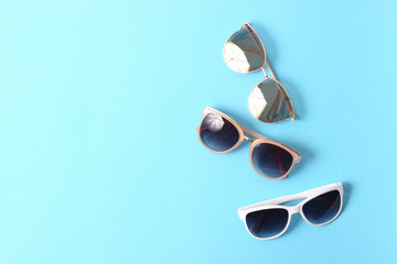 set of sunglasses on a colored background top view.
