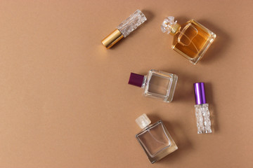 set of different perfumes on a colored background top view.