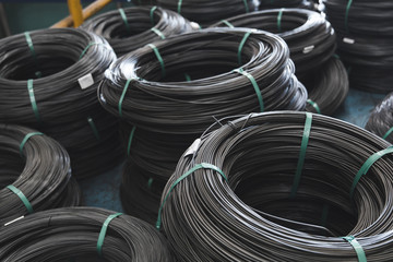 Pile of iron, metal wire rod or coil background for Construction industry. steel wire fence rolls. Steel wire tie rolls for construction and industrial. Coil of iron or steel background. - obrazy, fototapety, plakaty