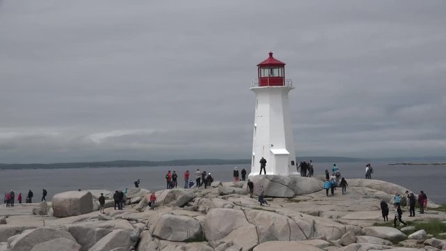 Tourists are photographed near the lighthouse.