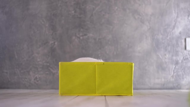 Little white rabbit sitting in a yellow box