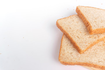 Close up brown sliced whole wheat bread isolated on white background.Healthy homemade sandwich breakfast preparing.Cooking bio ingredients.Food background concept with copy space.Top view.