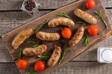 Grilled sausages with tomatoes , pepper and rosemary