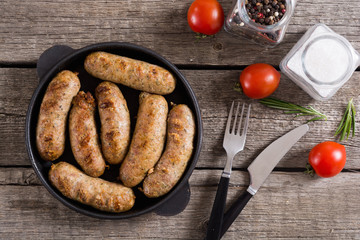 Grilled sausages with tomatoes , pepper and rosemary
