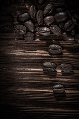 Heap of coffee grains on wooden board