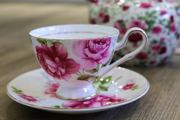 Obraz na płótnie Canvas Antique floral tea set including tea pot, saucer and cup