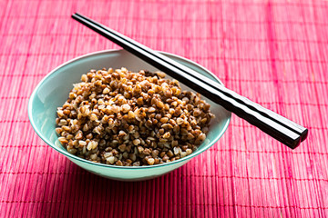 bowl full of buckwheat and chopsticks