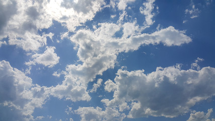 beautiful background of clouds, clearly visible lines of white clouds and blue sky, the top is a sunbeam