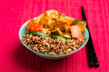 goulash with vegetables in a green bowl