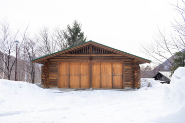 Wooden barn in the snowy forest.