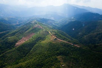 Fototapeta na wymiar Aerial view of mountain dirt road and rice terraces.