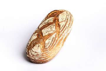 Fresh home-made bread with a crispy crust, on white background.
