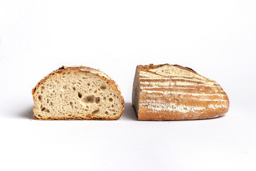 Fresh home-made bread with a crispy crust, on white background.