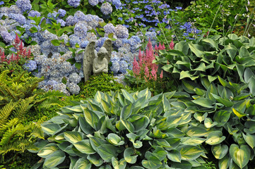 Stone angel in summer garden