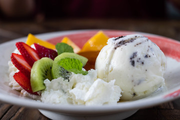 Pudding and ice cream with fresh fruit.