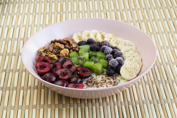 Oatmeal with banana, cherries, kiwi, blueberries, walnuts