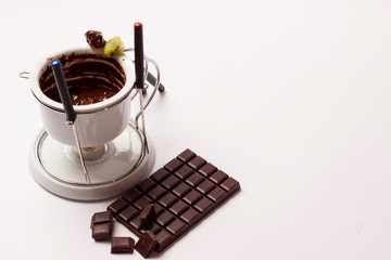 Chocolate fondue on white background