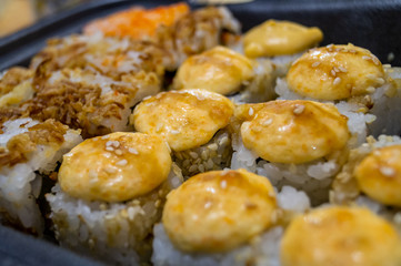 Hot fried Sushi Roll with salmon, avocado and cheese. Sushi menu. Japanese food.