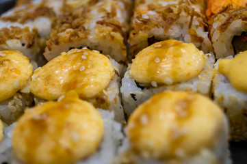 Hot fried Sushi Roll with salmon, avocado and cheese. Sushi menu. Japanese food.