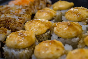 Hot fried Sushi Roll with salmon, avocado and cheese. Sushi menu. Japanese food.