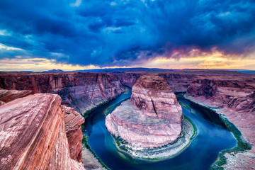 Horseshoe Bend on Colorado River at Sunset with Dramatic Cloudy Sky, Utah