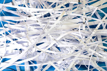 Closeup view of shredded paper on blue background