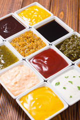 Set of different sauces in ceramic bowl