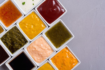 Set of different sauces in ceramic bowl