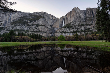 Yosemite Falls and reflection on Merced River, El Capitan Meadow, California