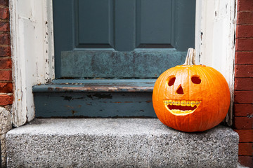 funny Halloween pumpkin on the doorstep. smiling pumpkin with braces. the concept of dentist office. copy space for your text
