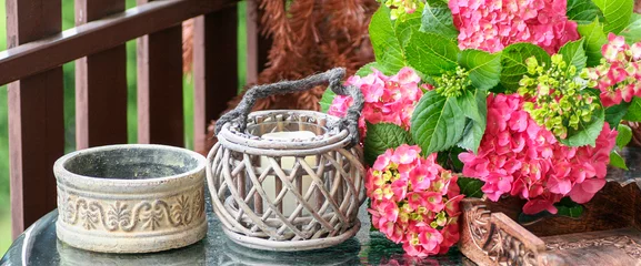 Foto auf Acrylglas Balcony decoration with hydrangea flowers and lanterns. © agneskantaruk