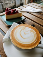 cup of coffee and cake on wooden table